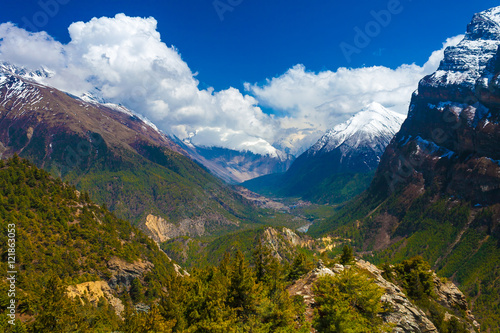 Landscape Snow Mountains Nature Viewpoint.Mountain Trekking Landscapes Background. Nobody photo.Asia Travel Horizontal picture. Sunlights White Clouds Blue Sky. Himalayas Hills.