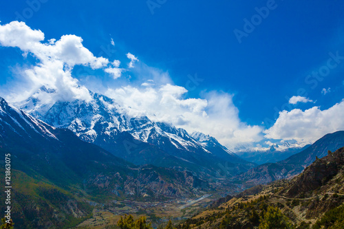 Landscape Snow Mountains Nature Viewpoint.Mountain Trekking Landscapes Background. Nobody photo.Asia Travel Horizontal image. Sunlights White Clouds Blue Sky. Himalayas Hills.