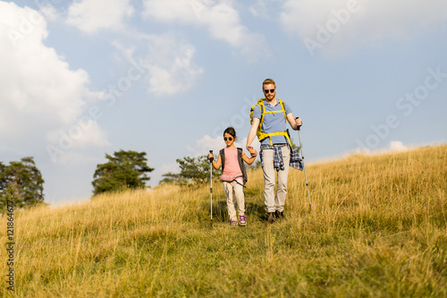 Father and daughter hiking © BGStock72