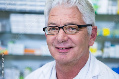 Smiling pharmacist in spectacles
