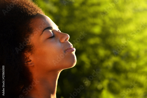 young happy and pretty afro wooman closeup portrait on natural background