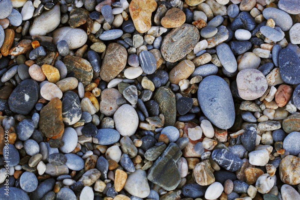 A close up view of smooth polished multicolored stones washed a A close up view of smooth polished multicolored stones washed a