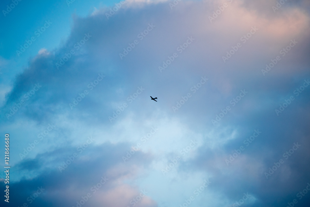 Zlin Z-526F acrobatic airplane flying on cloudy sky Zlin Z-526F acrobatic airplane flying on cloudy sky
