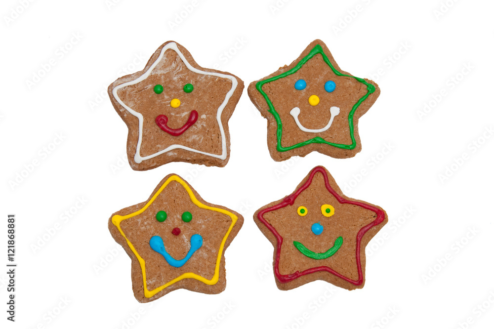 Smiling star shaped Christmas gingerbread cookies on white background