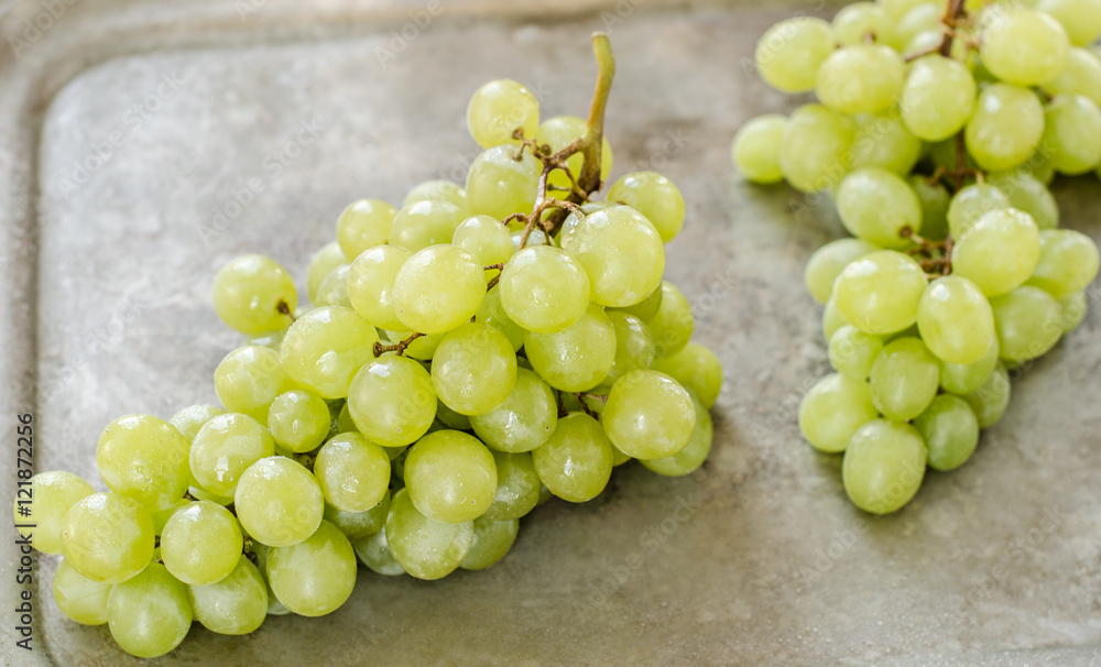 bunch green grapes on metal background, food closeup