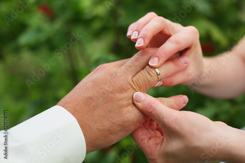 hands of the bride  put the ring on the groom © oksnemova