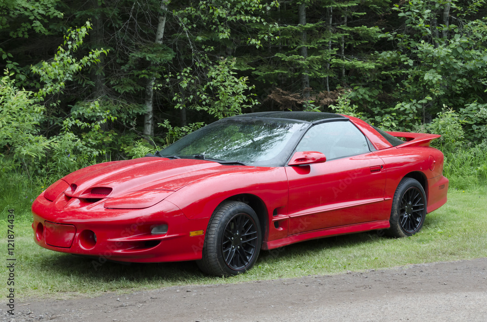 Bright Red American Sportscar Wet from the Rain Bright Red American Sportscar Wet from the Rain