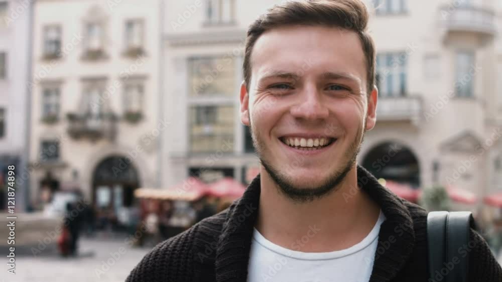 Slow Motion Portrait of happy cute caucasian man smiling in city real people series Slow Motion Portrait of happy cute caucasian man smiling in city real people series