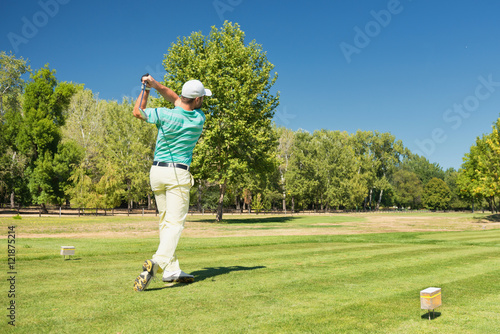 Golf. Golfer playing from tee box