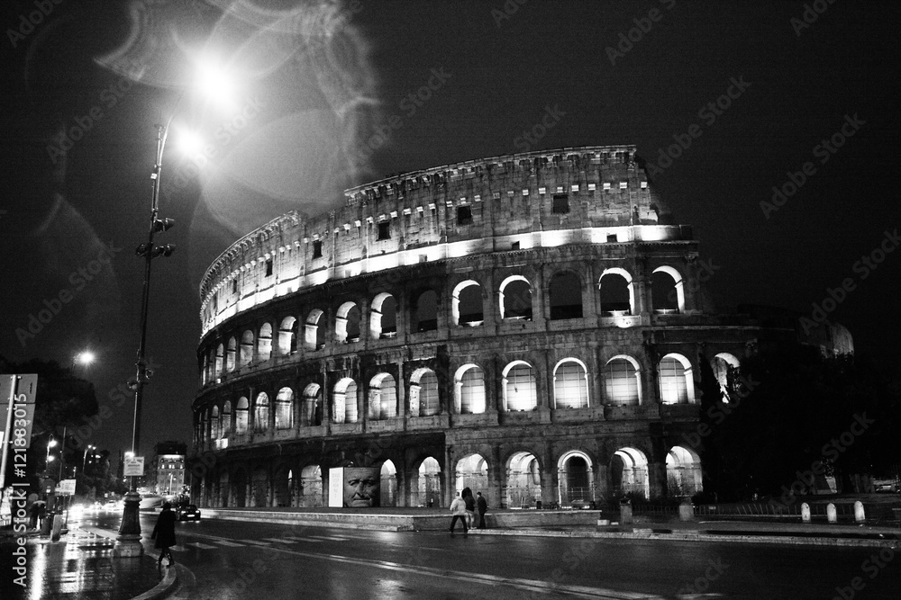 Night on the streets in Rome with the Colosseum.