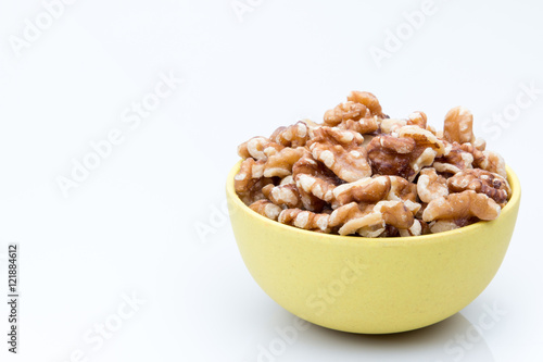 Bowl of walnuts on a white background.