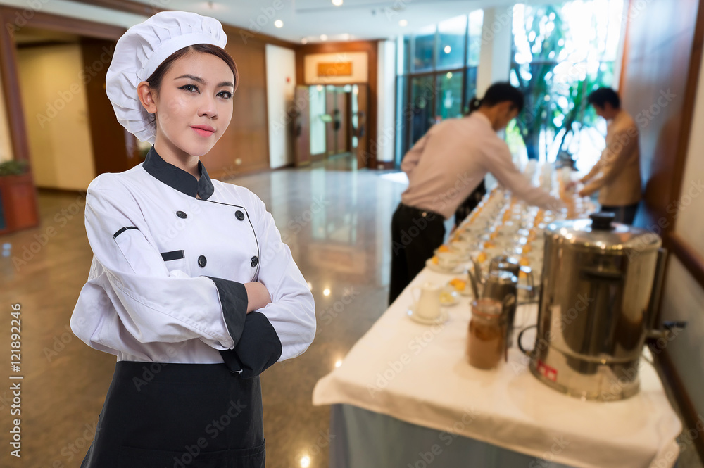 Attractive cook asian woman over front auditorium background.