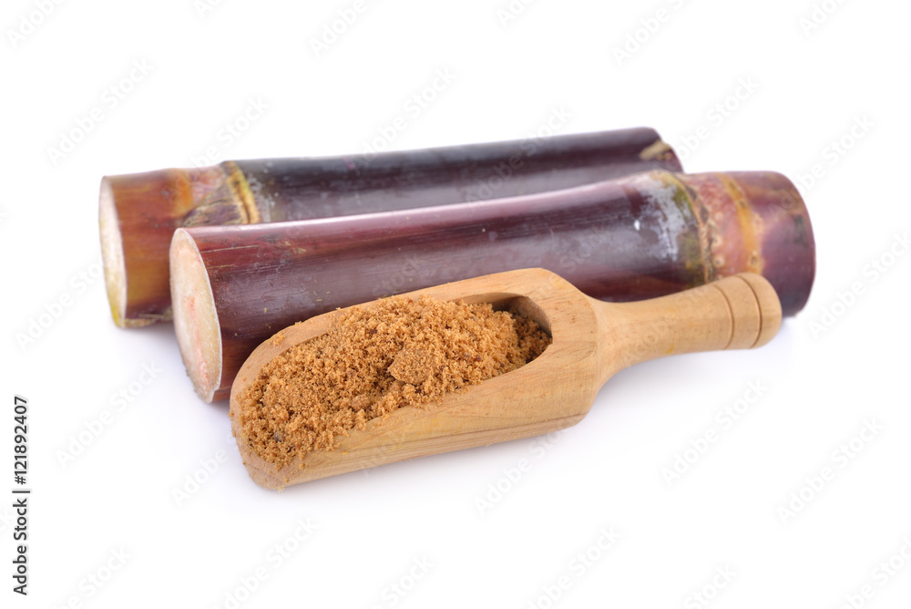 sugar cane and brown sugar on white background
