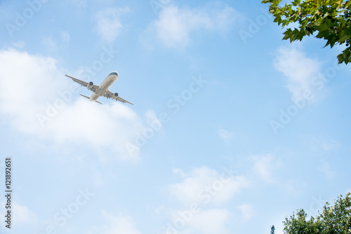 commercial plane flying against blue sky,china.