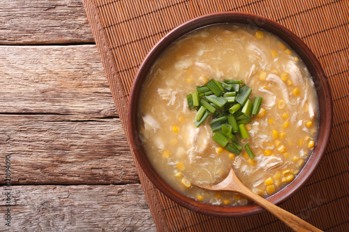 Chinese corn and chicken soup in a bowl close-up. horizontal top view
