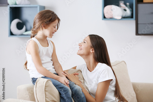 Cute girl with mother at home