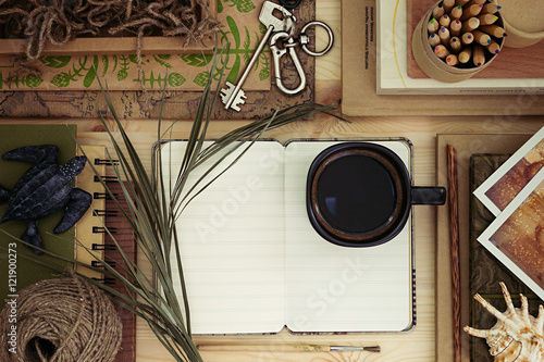 The workplace traveler. The blank notebook. The presentation. Adventure vacation background. Craft, hipster, wood background.
