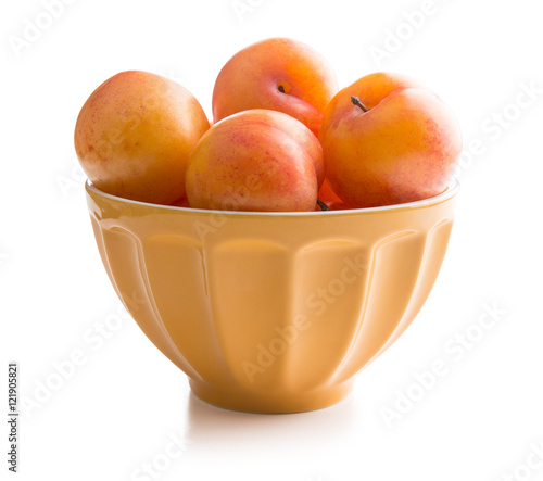 Ripe yellow plums in bowl.