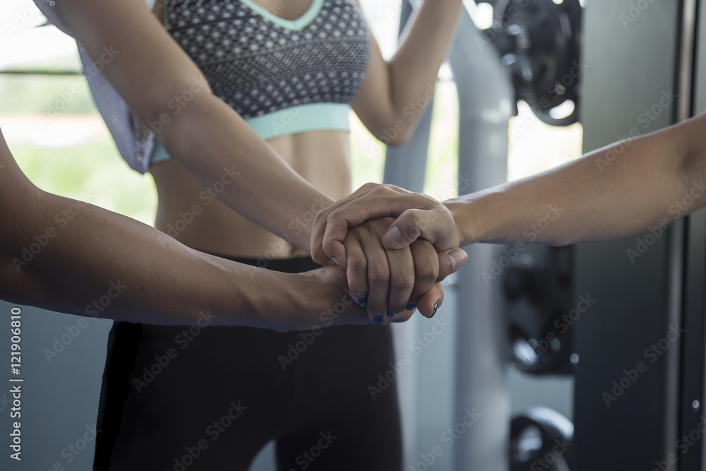 Fototapeta premium Teamwork concept,Exercise team standing hands together in the gy