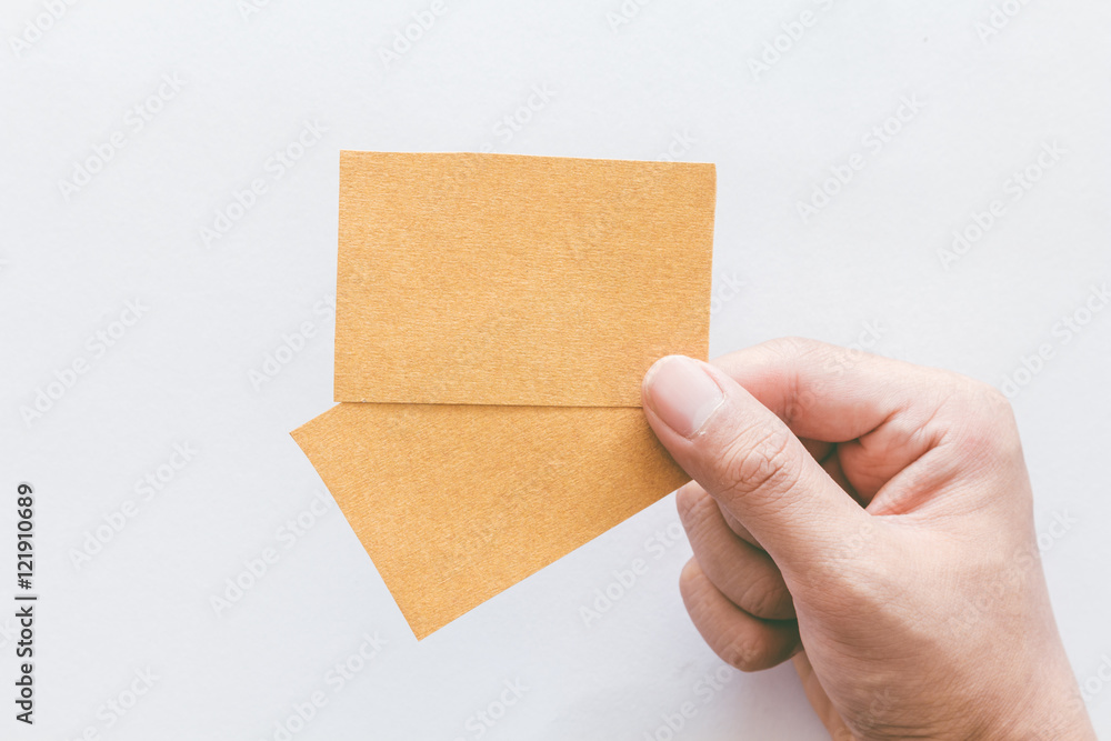 Hand holding paper on white background Hand holding paper on white background