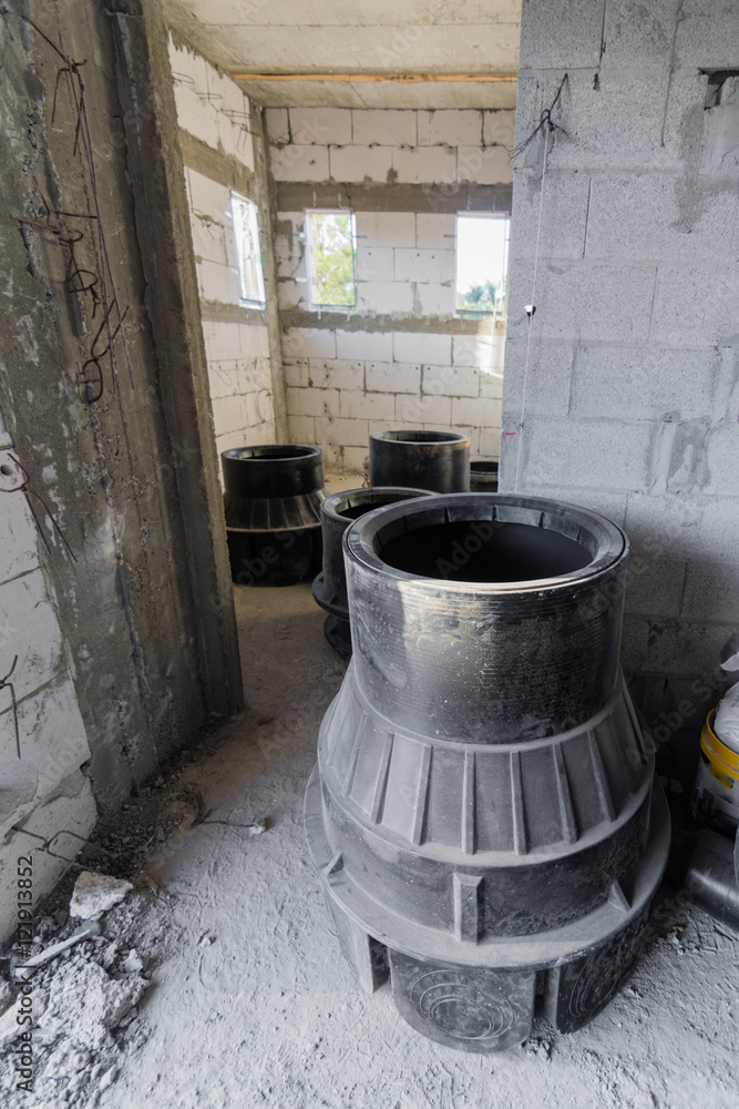 Sewage equipment Inside a brick and concrete house under constru Sewage equipment Inside a brick and concrete house under constru