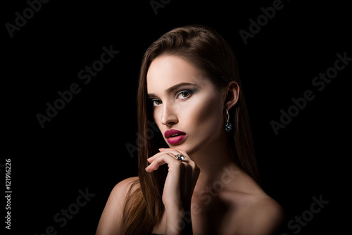 Beauty portrait of girl with jewelry on black background