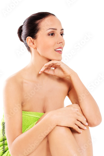 Beautiful woman in towel sitting on the floor
