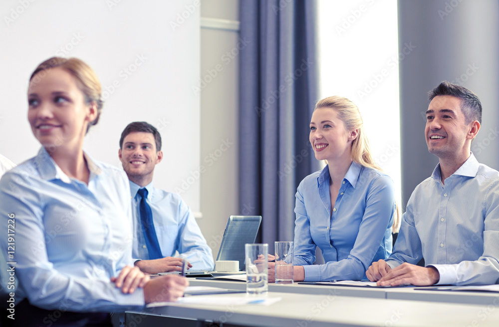 group of smiling businesspeople meeting in office group of smiling businesspeople meeting in office