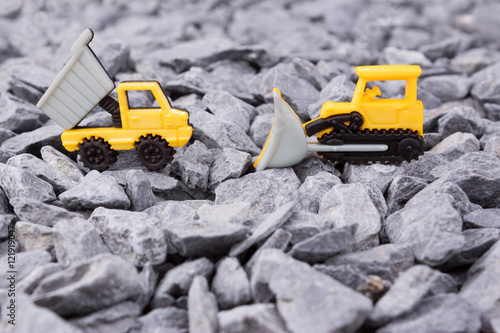 dumper truck and bulldozer on pebbles
