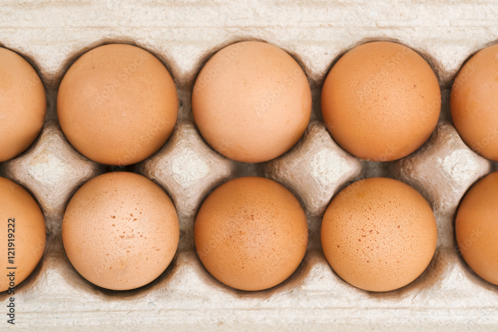 Brown eggs in cardboard package, top view Brown eggs in cardboard package, top view