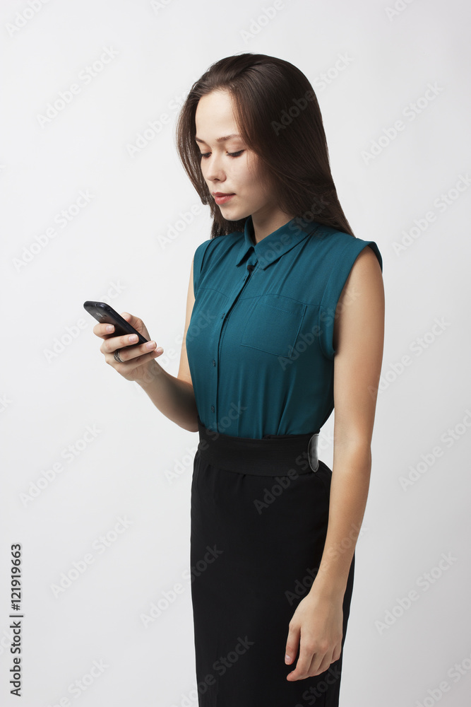 Beautiful brunette dials a number on your mobile phone Beautiful brunette dials a number on your mobile phone