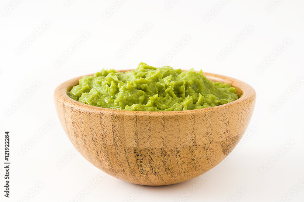 Guacamole in a wooden bowl isolated on white background
Guacamole in a wooden bowl isolated on white background