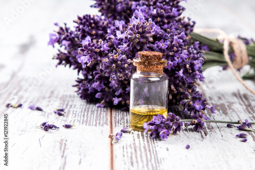 spa massage setting, lavender product, oil and christmas decoration on wooden background, Christmas wellness concept