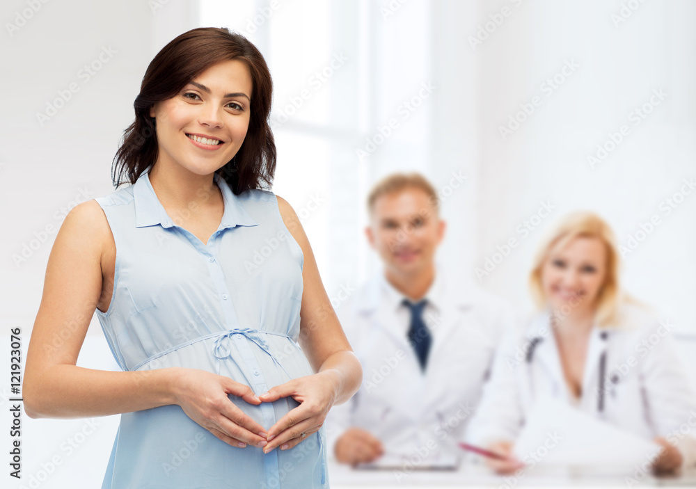happy pregnant woman making heart gesture on belly happy pregnant woman making heart gesture on belly