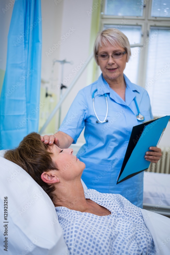 Fototapeta premium Nurse checking patient temperature