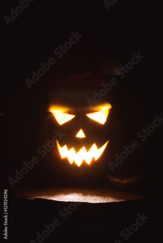 Jack-o ' - lantern scary shining eyes in the darkness.