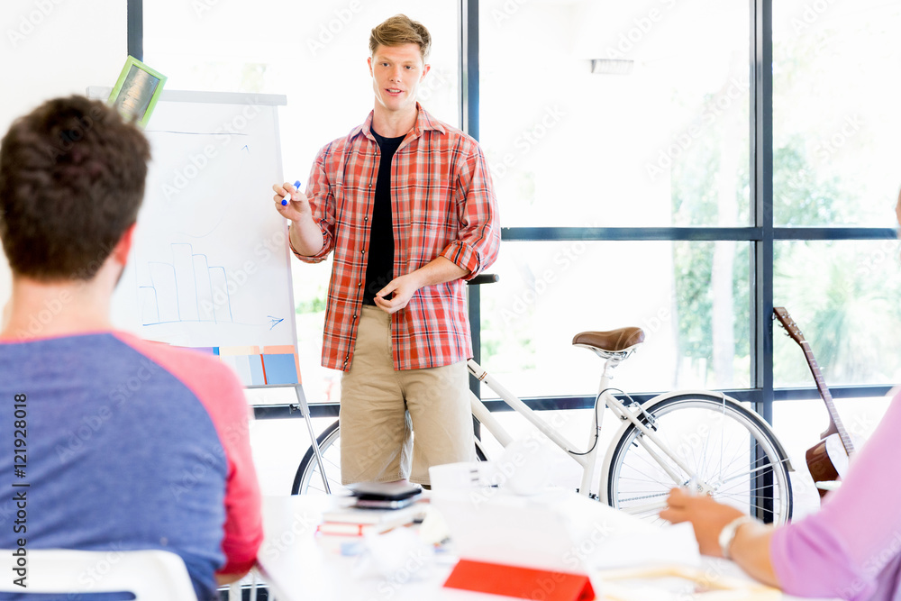 Casual businessman giving a presentation in the office