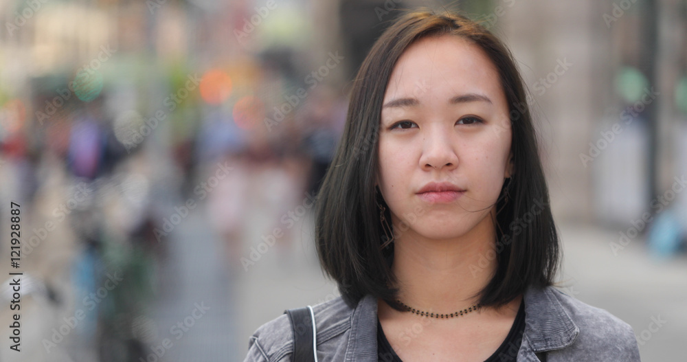 Young Asian woman in city face portrait