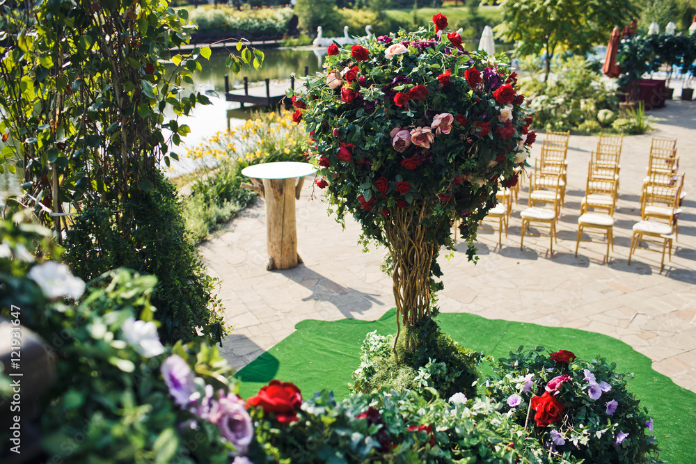 Fototapeta premium beautiful ikebana in front of chairs for guests