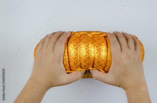 Thai silk Pumkin Pillow and hand on white background photo