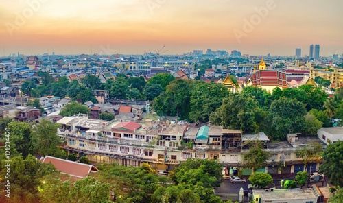 Obraz na płótnie Traditional architecture of Bangkok from the height of bird flight. View of Wat Ratchanatdaram Temple from Golden Mountain at sunset, Thailand. w salonie