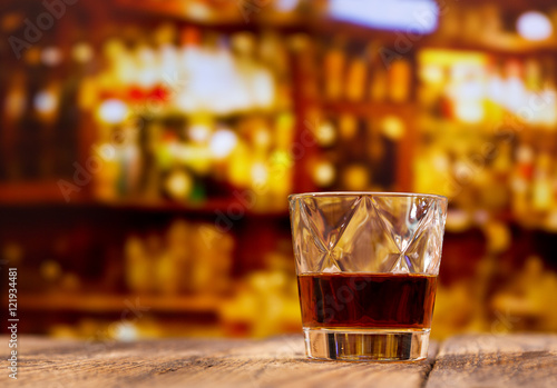 Fototapeta Naklejka Na Ścianę i Meble -  glass of whiskey on wooden table