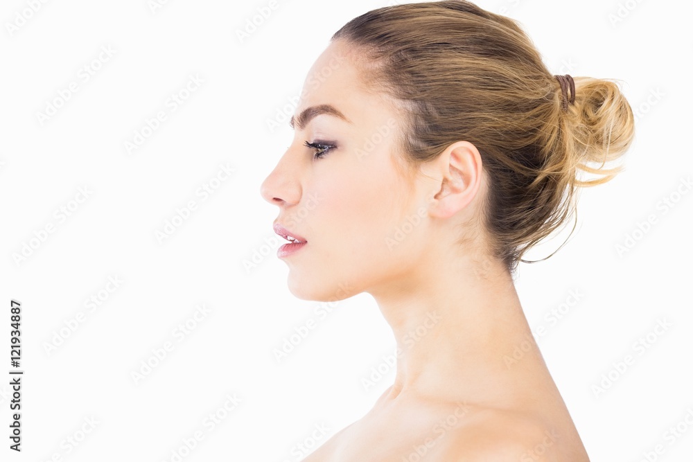 Side view of beautiful woman posing against white background Side view of beautiful woman posing against white background