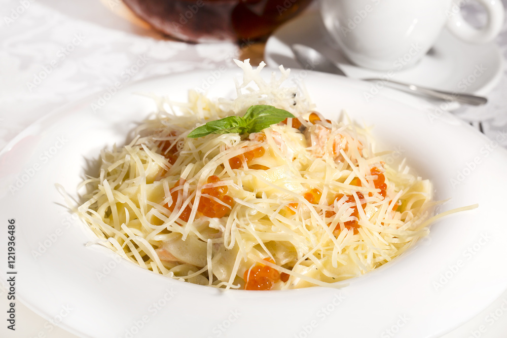 spaghetti with eggs decorated with greenery on a white background