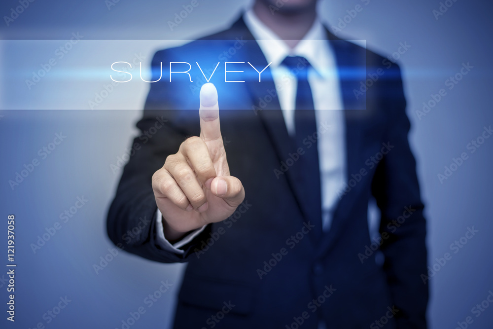 Businessman hand touching SURVEY button on virtual screen Businessman hand touching SURVEY button on virtual screen