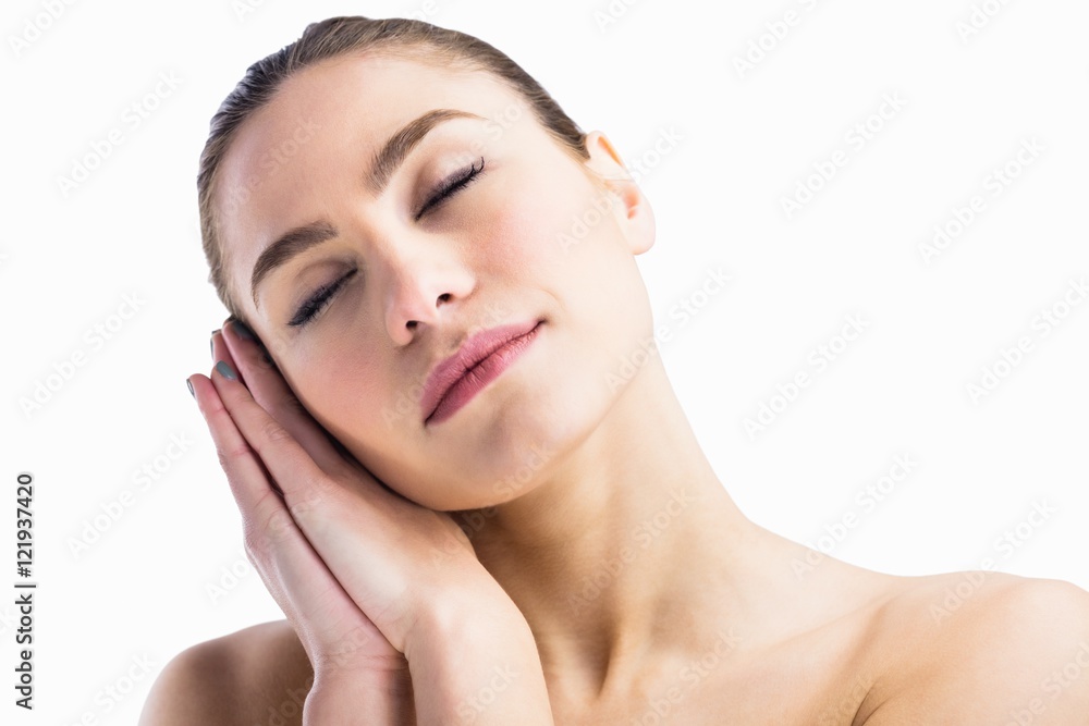 Woman posing with her eyes closed against white background Woman posing with her eyes closed against white background