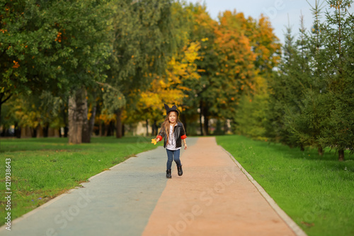 happy little girl walking in the park