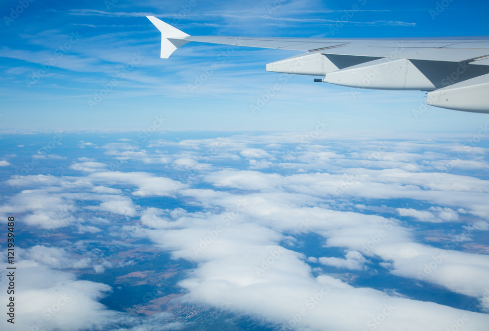 Fototapeta premium Beautiful airplane view above clouds