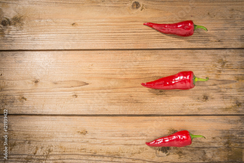 Red chili on wooden table background, Top view