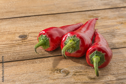Red chili on wooden table background.